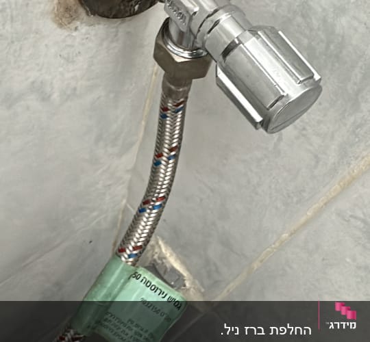 ברז וצינור מתכת מחובר לקיר